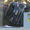Photo: In this image provided by Fox5, an SUV is wedged b Photo: In this image provided by Fox5, an SUV is wedged b