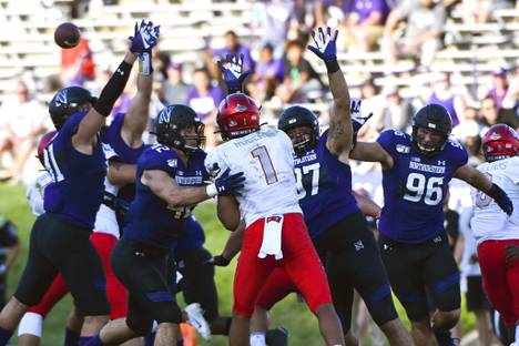 UNLV quarterback Armani Rogers (1) is defended by Northwestern defensive lineman Samdup Miller, left, linebacker Paddy Fisher (42), defensive lineman Joe Gaziano (97) and defensive end Trevor Kent (96) during the second half of an NCAA college football game, Saturday, Sept. 14, 2019, in Evanston, Ill.