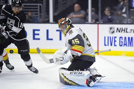 Golden Knights goaltender Oscar Dansk deflects a shot as Kings left wing Alex Iafallo reaches for the puck during the second period of a preseason NHL hockey game Thursday, Sept. 19, 2019, in Los Angeles.