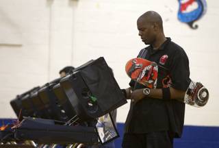 Stanley Hollman, a bartender at the Mandalay Bay, votes on election day at the Fremont Middle School gym Tuesday, November 6, 2012. Without a ride but determined to vote, Hollman set off to the polls on his skateboard. A co-worker in a car spotted him on the way and gave him a ride for part of the journey, he said. STEVE MARCUS